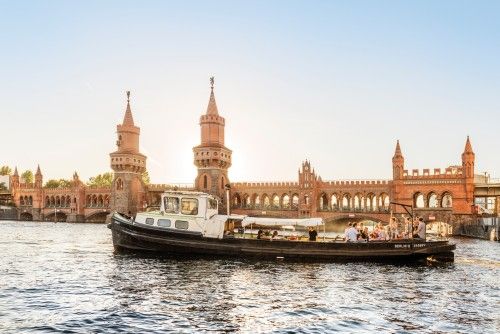 Boot auf der Spree vor der Oberbaumbrücke bei Sonnenuntergang